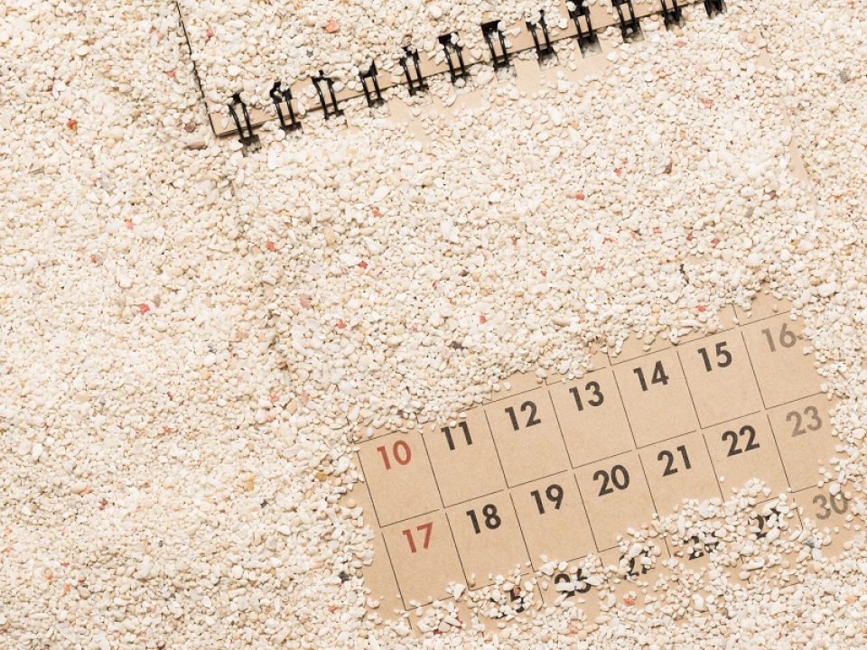 calendar with sand and pebbles