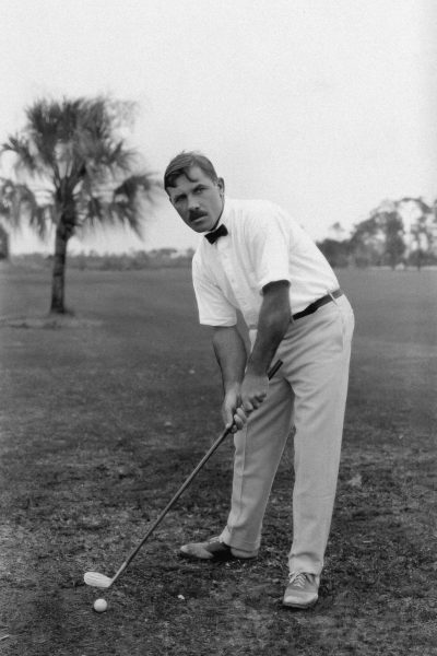 Vintage black and white photo of a man playing golf