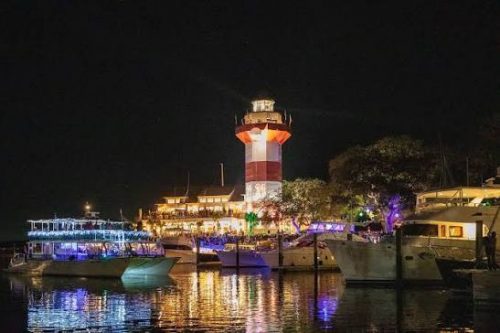 Harbour Town Lighthouse and marina lit up at night